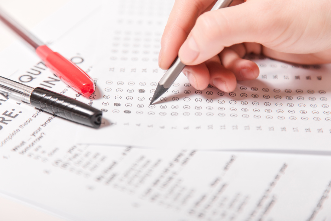 Test of English multiple choice on table.Woman takes an entrance exam